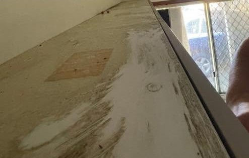 Grimy laundry benchtop before cleaning